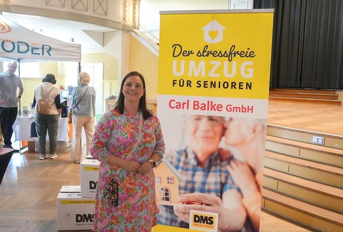 Mitarbeiterin von DMS Carl Balke am Messestand bei der Seniorenmesse Holzminden
